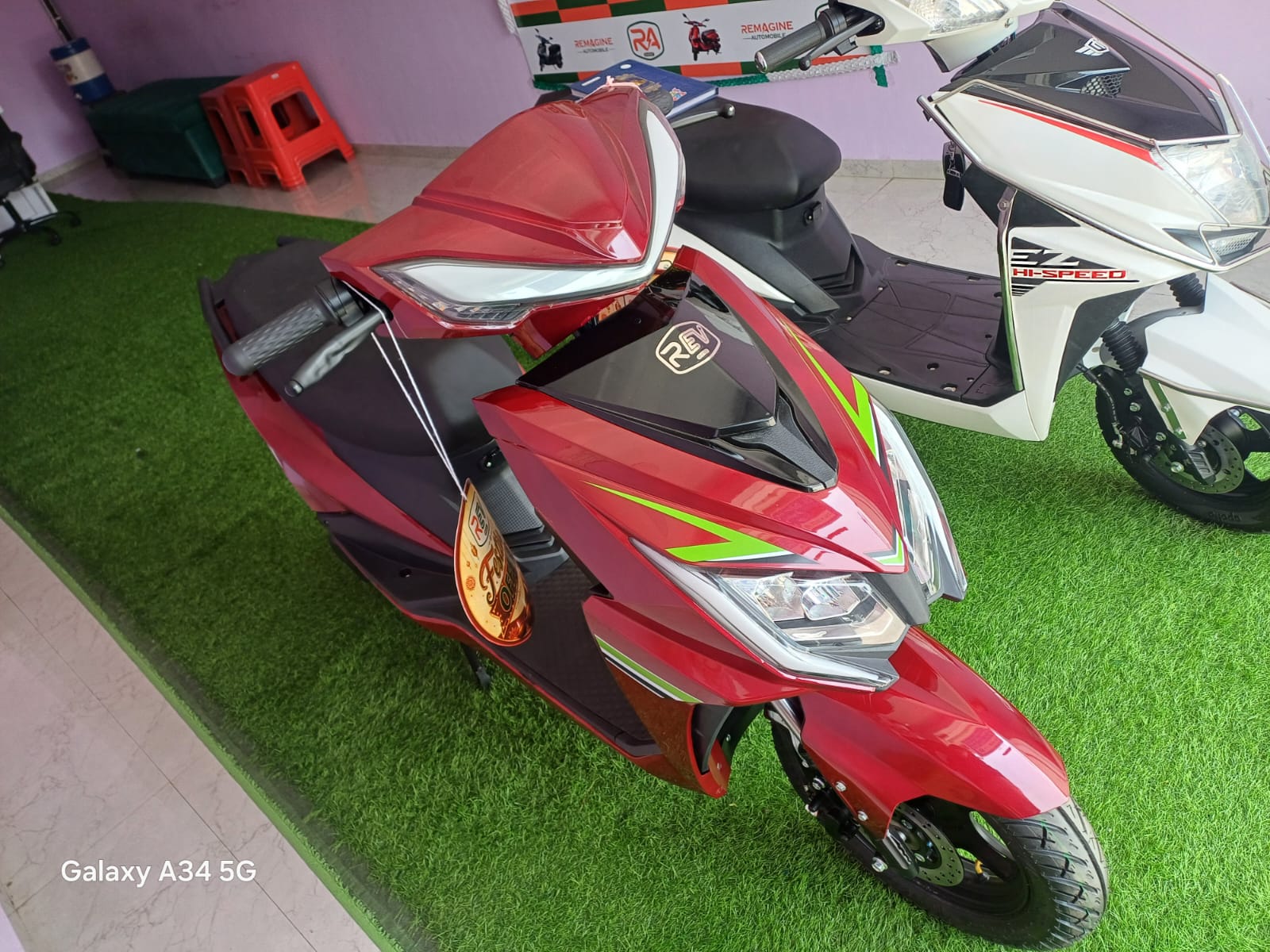 REV EON electric scooter in red, front three-quarter view