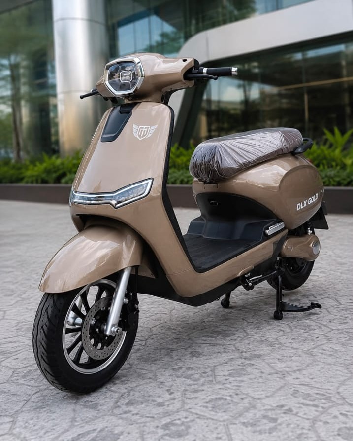 DLX Gold RTO electric scooter in champagne gold, front three-quarter view